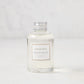 Hudson Grace Montauk scented reed diffuser oil refill, clear glass bottle with silver cap and white label.