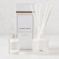 Hudson Grace Montauk Scented Reed Diffuser set: clear glass bottle, frosted glass vessel with white reeds, and white box.