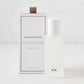 Hudson Grace Montauk 5.08 oz frosted glass room spray bottle with white cap next to its white and gold box.