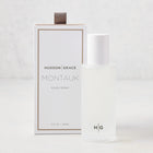 Hudson Grace Montauk 5.08 oz frosted glass room spray bottle with white cap next to its white and gold box.