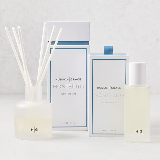Hudson Grace Montecito Room Spray and Diffuser Gift Set: frosted glass bottles, white boxes with blue accents.