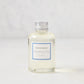 Hudson Grace Montecito 4oz clear glass diffuser oil refill bottle with silver cap and blue label.