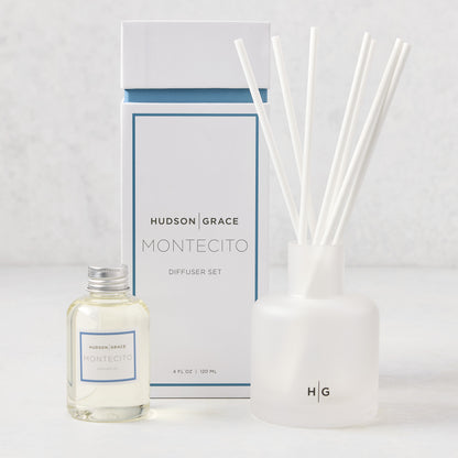 Hudson Grace Montecito reed diffuser set: frosted white glass vessel, 6 white reeds, oil bottle, and box.