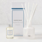 Hudson Grace Montecito reed diffuser set: frosted white glass vessel, 6 white reeds, oil bottle, and box.