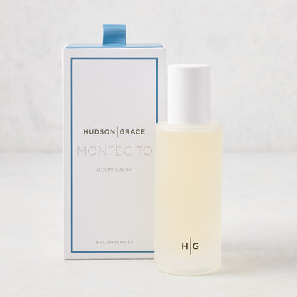 Hudson Grace Montecito 5 oz room spray in a frosted glass bottle with white cap, beside its white and blue box.