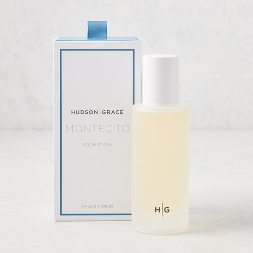 Hudson Grace Montecito 5 oz room spray in a frosted glass bottle with white cap, beside its white and blue box.