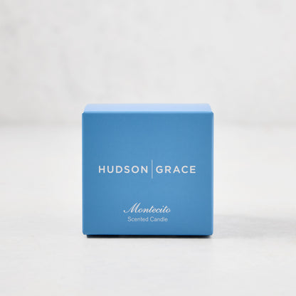 Hudson Grace Montecito Scented Votive in a blue gift box with white text.