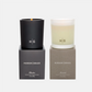 Hudson Grace New York Scented Candle Gift Set: a black Bleecker candle and a frosted Montauk candle in glass vessels.
