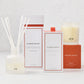 Hudson Grace Original Scent Gift Set: white diffuser, room spray, and candle with orange accents.