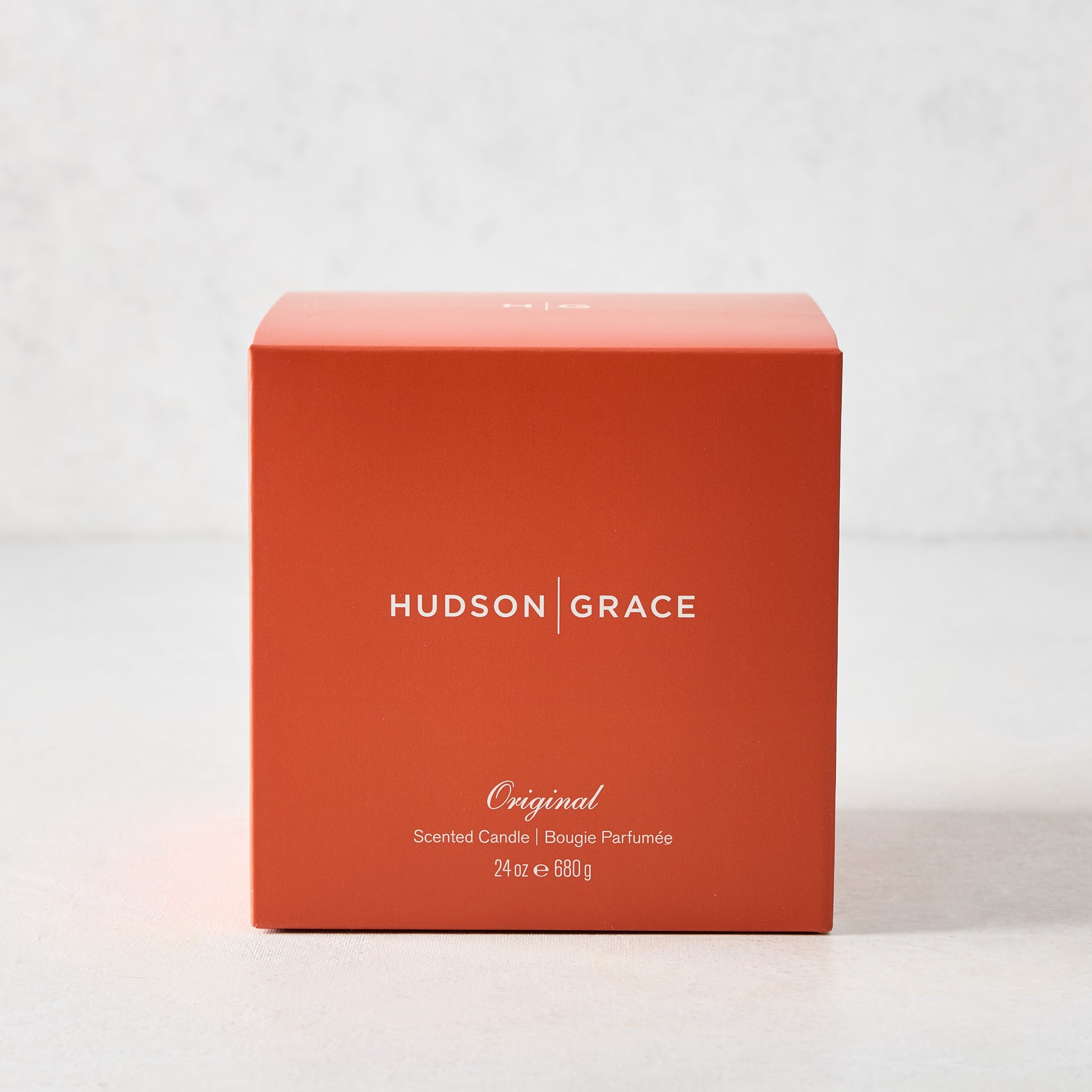 Hudson Grace Original Scented 3-Wick Candle in an orange box with white text, 24 oz.