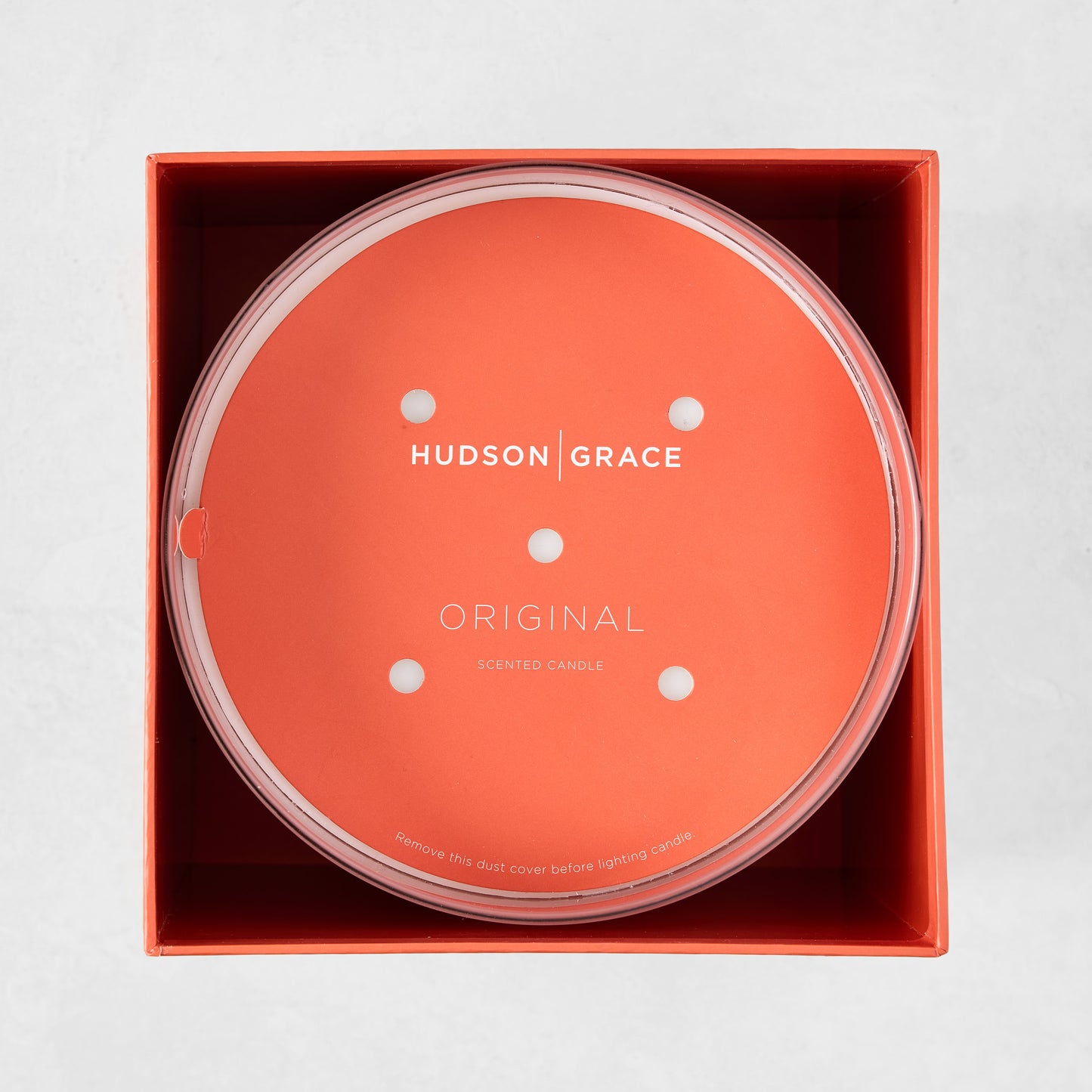 Hudson Grace Original Scented 4-Wick Candle in an orange box, with a clear lid and orange dust cover.