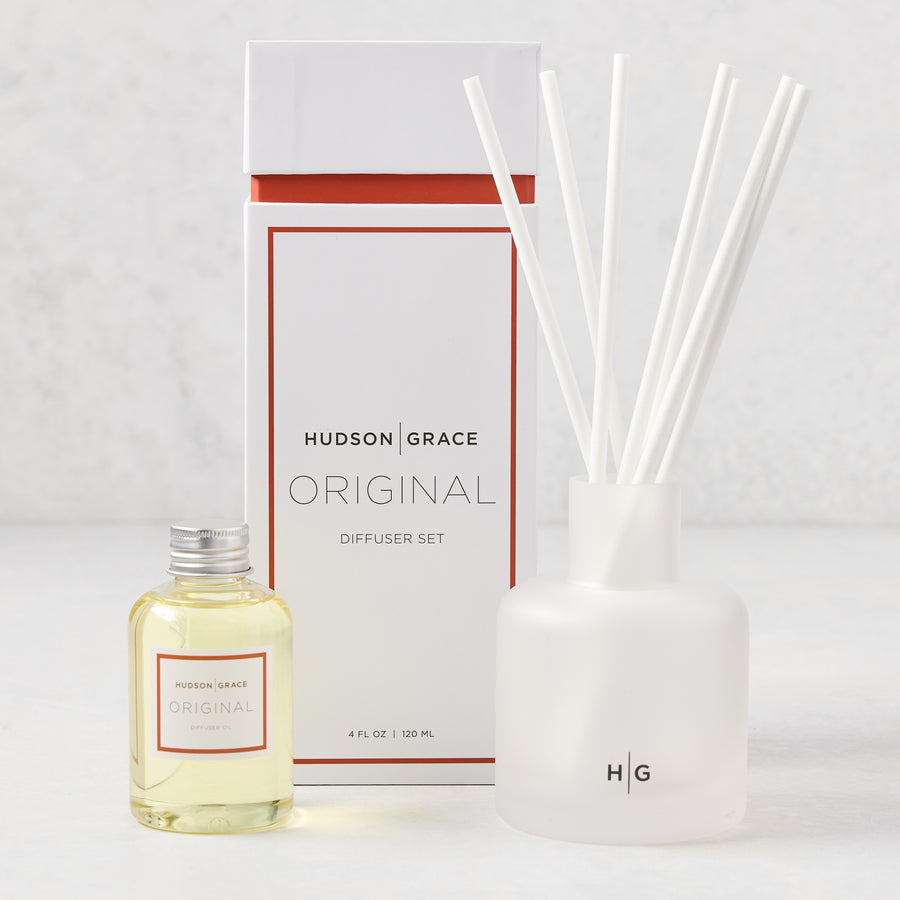 Hudson Grace Original Scented Diffuser set with frosted glass vessel, white reeds, and oil bottle.