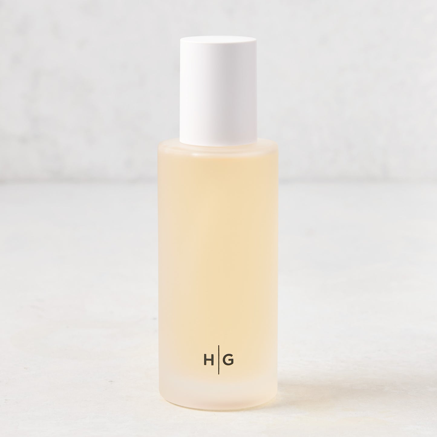 Hudson Grace Original Scented Room Spray in a frosted glass bottle with white cap and "HG" logo.