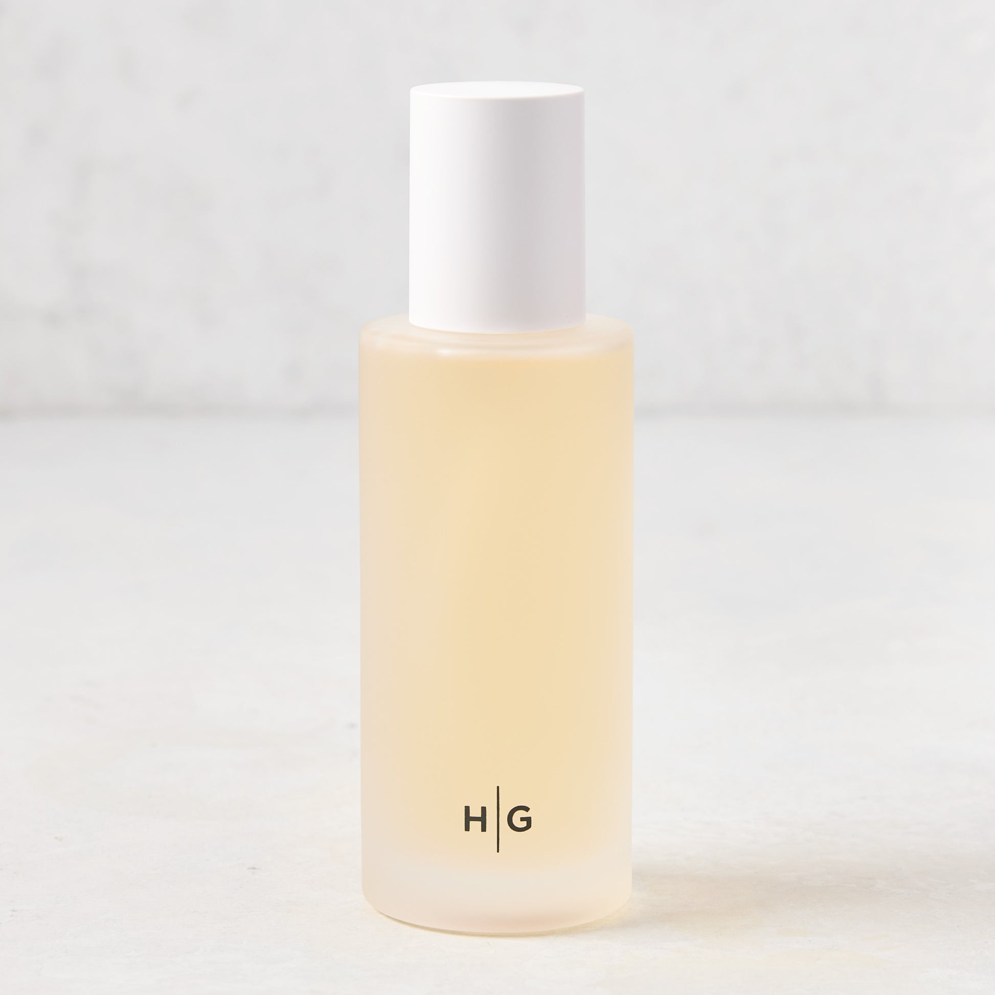 Hudson Grace Original Scented Room Spray in a frosted glass bottle with white cap and "HG" logo.