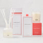 Hudson Grace Palm Beach scent gift set: white diffuser, room spray, and candle with coral accents.