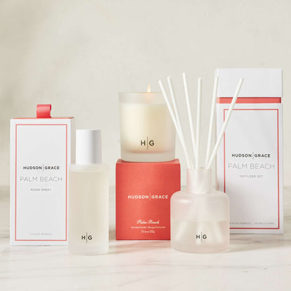Hudson Grace Palm Beach scented candle, room spray, and diffuser set in white and coral packaging.
