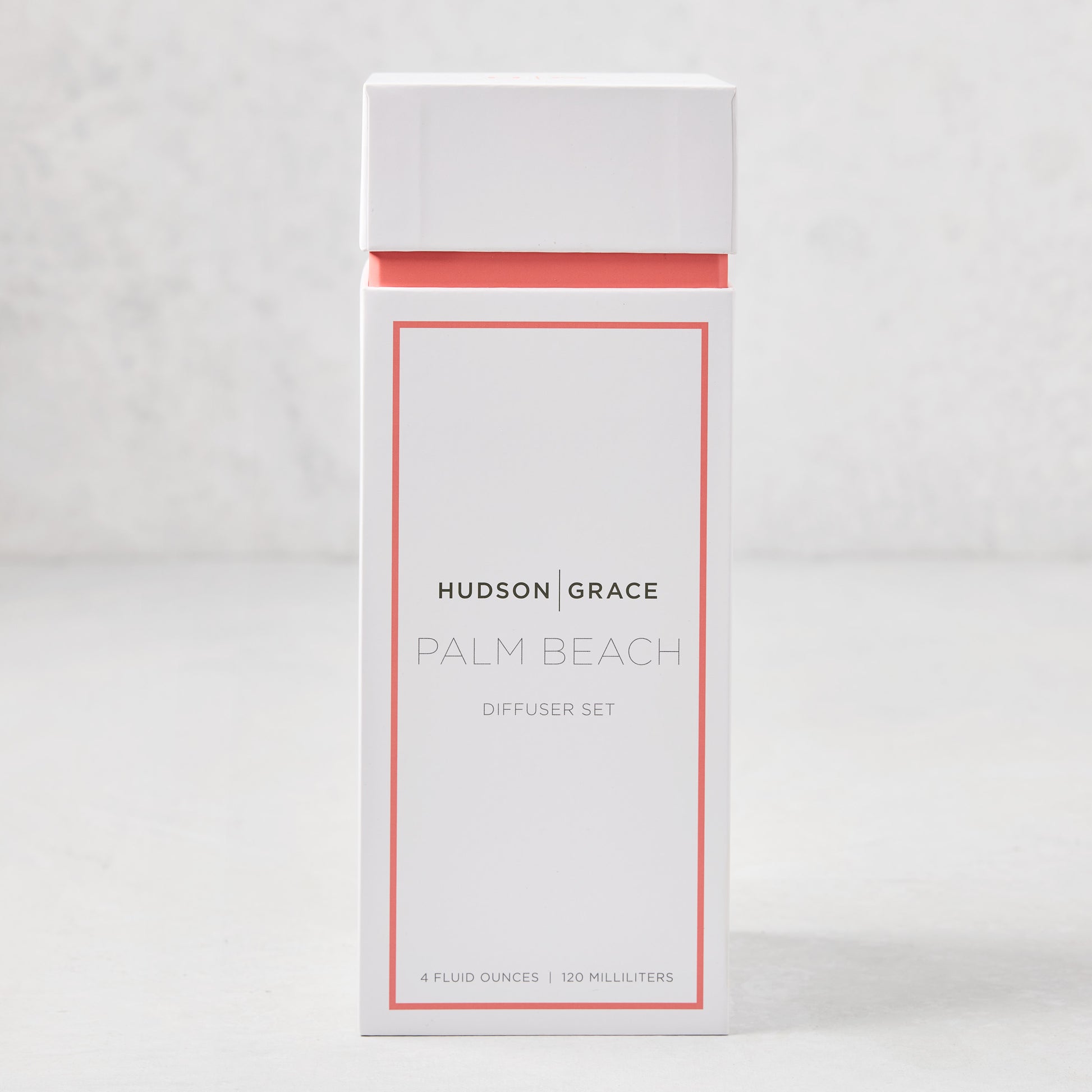 Hudson Grace Palm Beach scented reed diffuser set in a white box with coral trim.