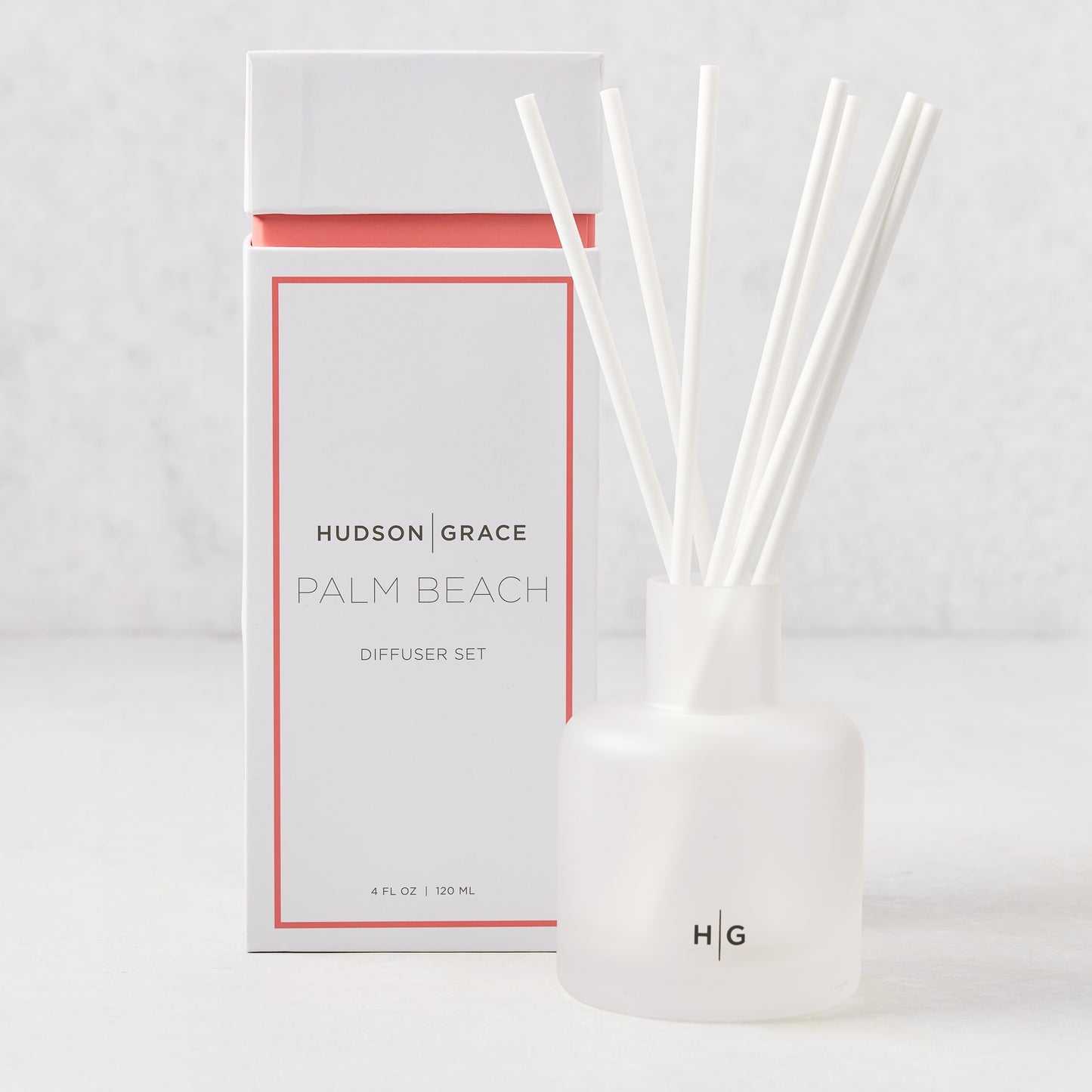Hudson Grace Palm Beach Scented Reed Diffuser with frosted glass vessel, white reeds, and white box.