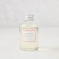 Hudson Grace Palm Beach scented diffuser oil refill, clear glass bottle with silver cap and pink label.