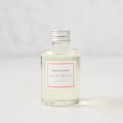Hudson Grace Palm Beach scented diffuser oil refill, clear glass bottle with silver cap and pink label.