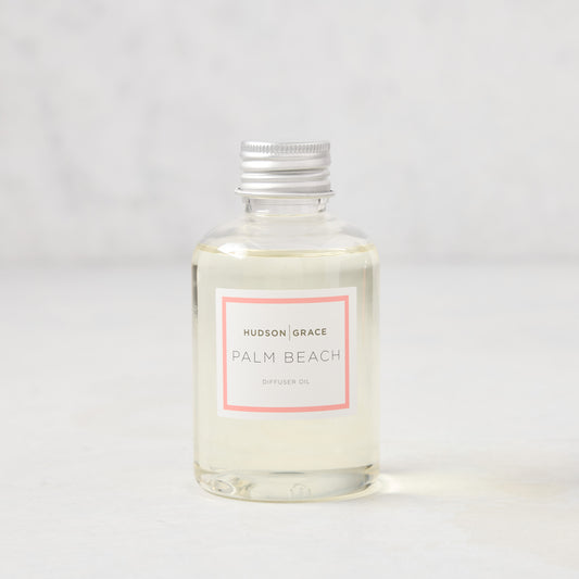 Hudson Grace Palm Beach scented diffuser oil refill, clear glass bottle with silver cap and pink label.