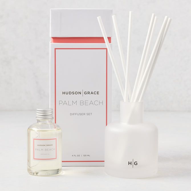 Hudson Grace Palm Beach reed diffuser set with frosted glass vessel, white reeds, and oil bottle.