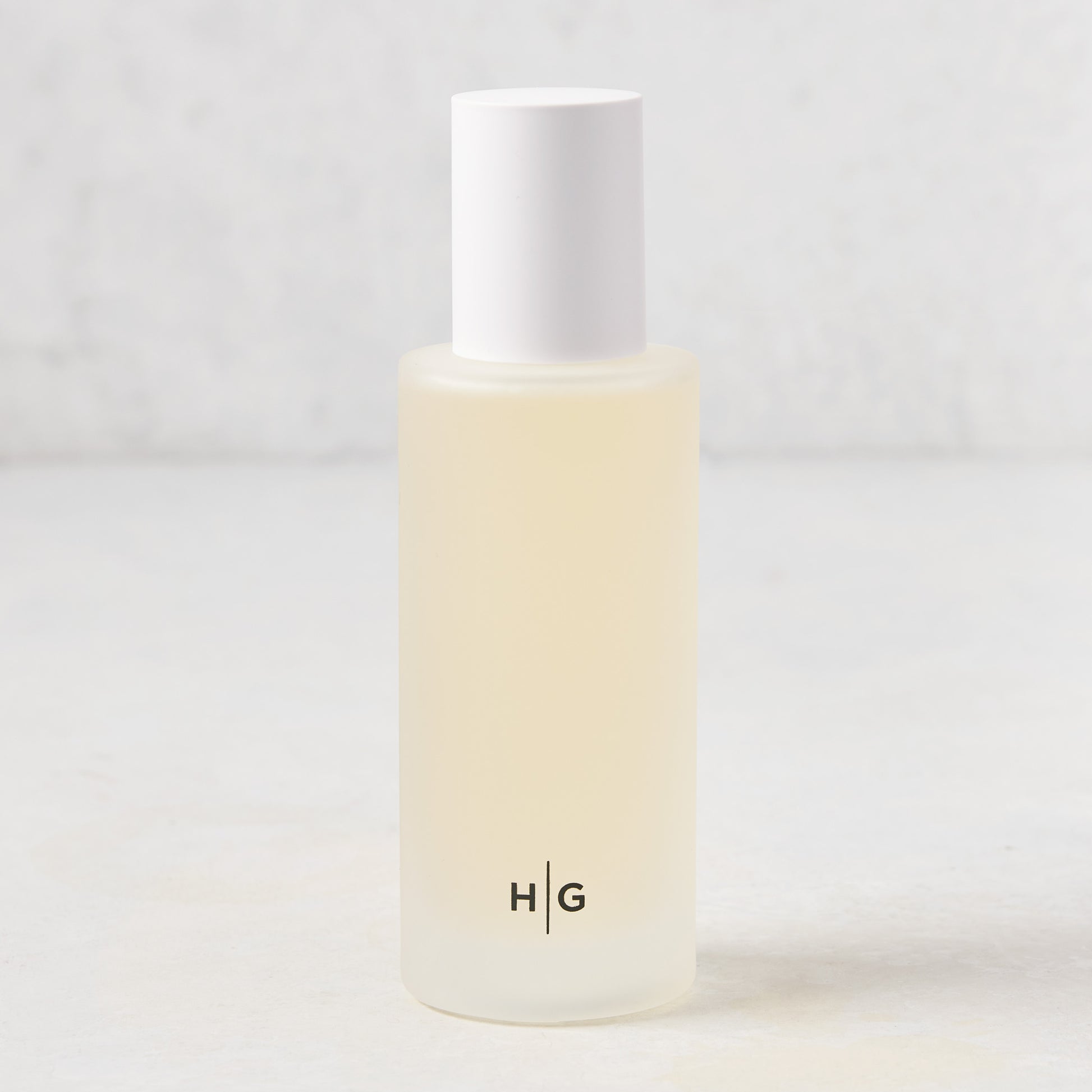 Hudson Grace Palm Beach Scented Room Spray in a frosted glass bottle with white cap and HG logo.