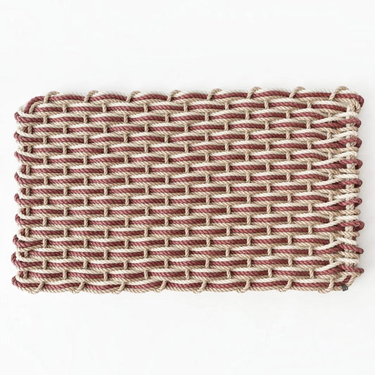 Hudson Grace handwoven rope doormat in pomegranate, sand, and oyster colors, suitable for all-weather outdoor use.