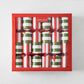 Set of 6 holiday crackers in a red box, featuring red, green, and white vertical striped paper with red ribbon ties.