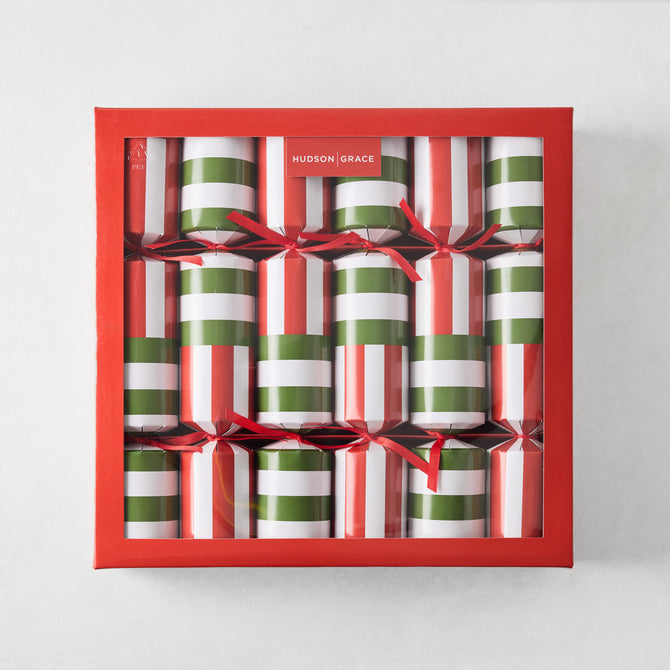 Set of 6 holiday crackers in a red box, featuring red, green, and white vertical striped paper with red ribbon ties.