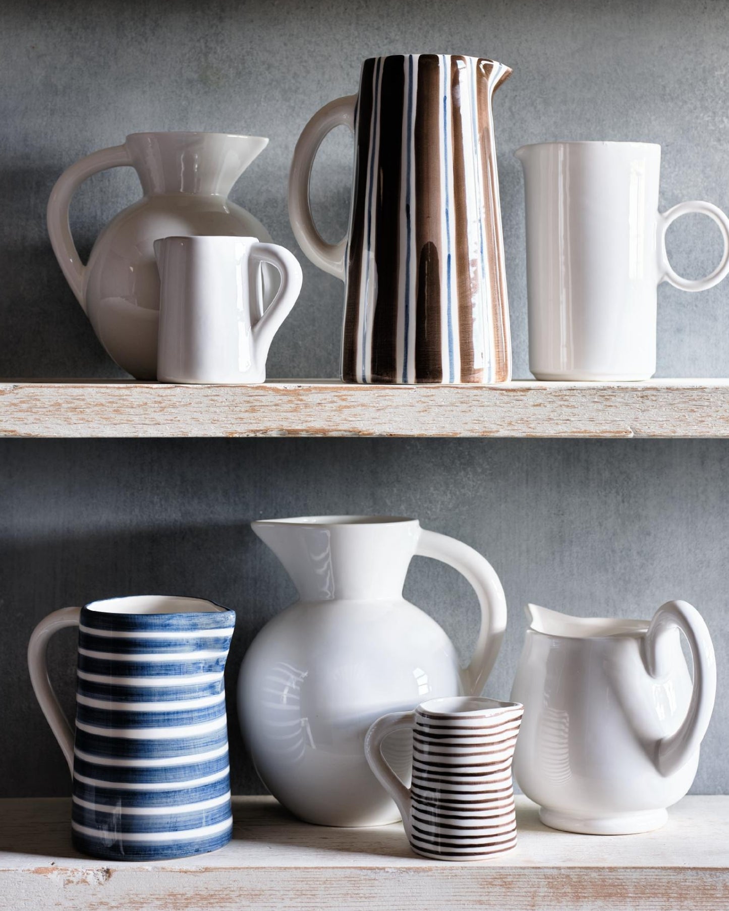Hudson Grace Salerno striped and white ceramic pitchers displayed on shelves