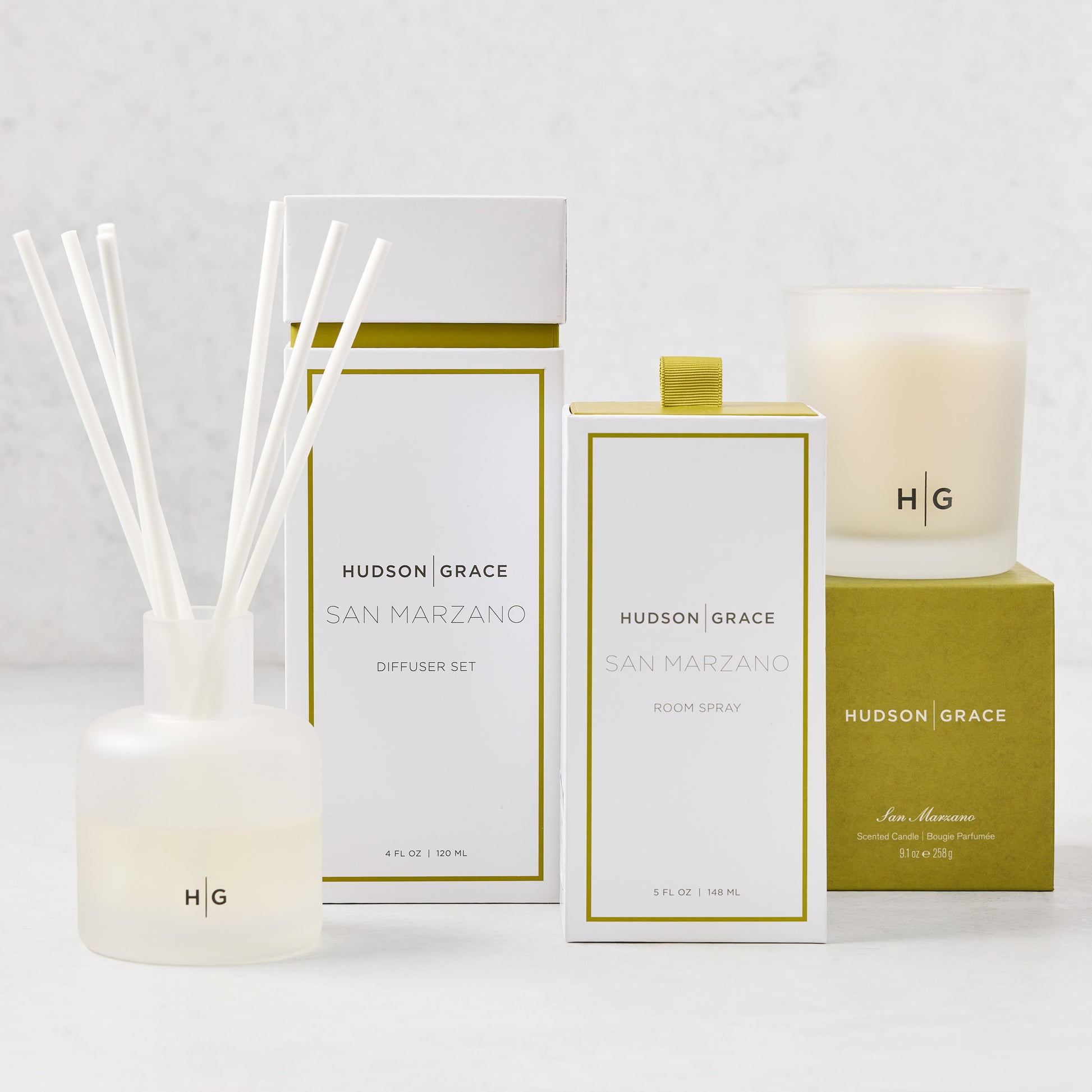 Hudson Grace San Marzano scent gift set: white diffuser, room spray, and candle with olive green accents.