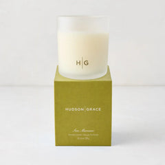 Hudson Grace San Marzano scented candle in a frosted glass vessel with HG logo, on a green box.