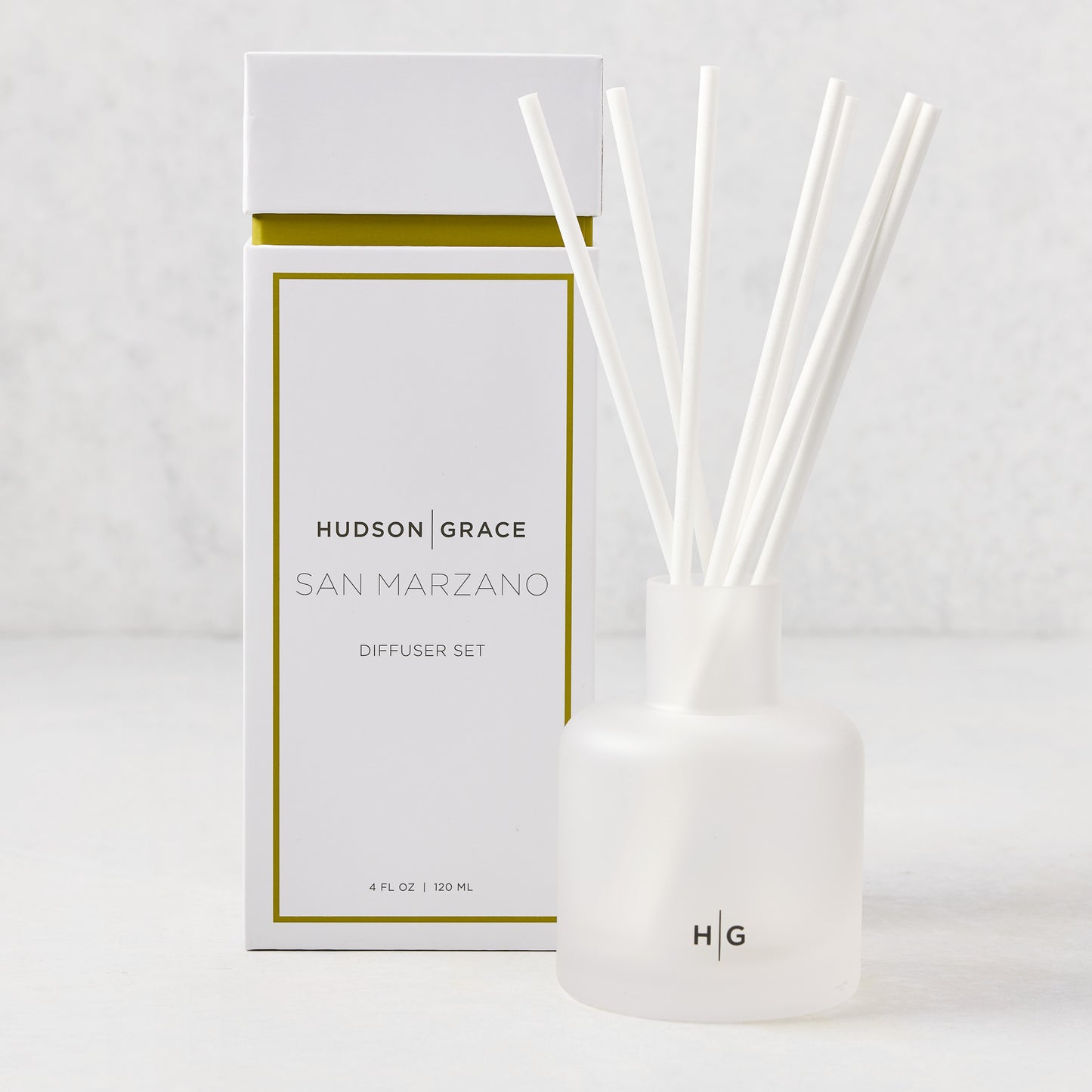 Hudson Grace San Marzano reed diffuser set with frosted glass vessel, white reeds, and white box with gold trim.