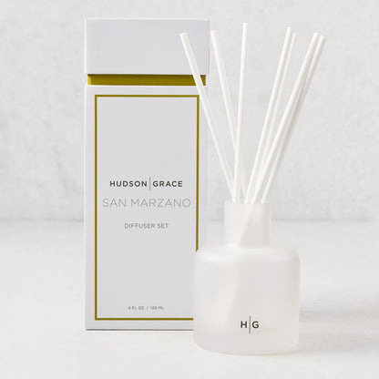 Hudson Grace San Marzano reed diffuser set with frosted glass vessel, white reeds, and white box with gold trim.