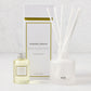 Hudson Grace San Marzano reed diffuser set: frosted glass vessel, white reeds, oil bottle, and white box with gold trim.