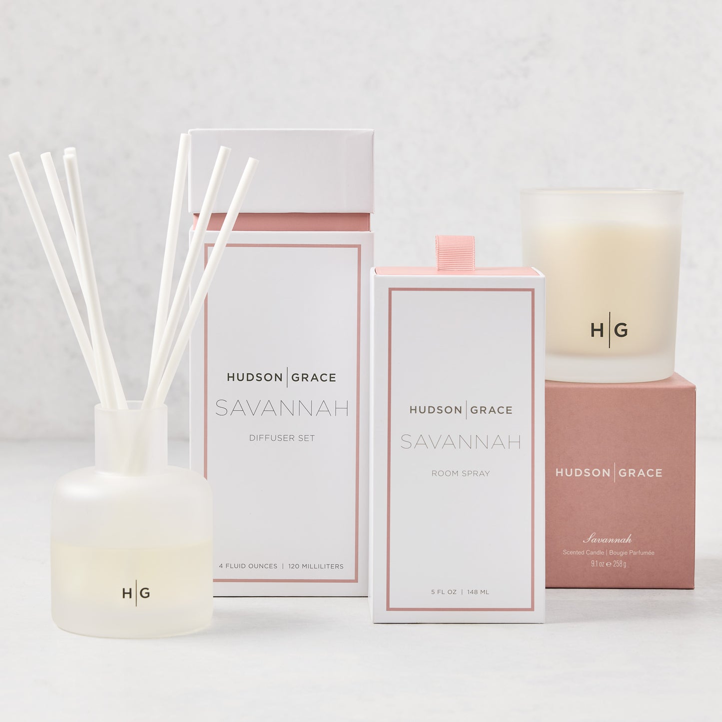 Hudson Grace Savannah Scent Gift Set: white candle, diffuser with reeds, and room spray in elegant packaging.