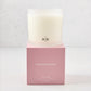 Hudson Grace Savannah 3-wick candle in a frosted glass vessel with HG logo, on a pink gift box.