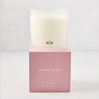 Hudson Grace Savannah 3-wick candle in a frosted glass vessel with HG logo, on a pink gift box.