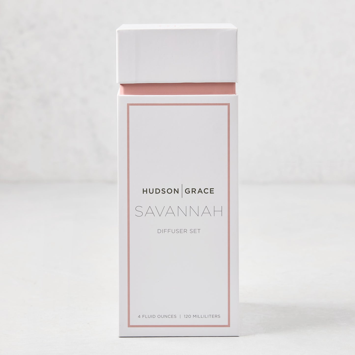 Hudson Grace Savannah scented reed diffuser set in a white and blush pink box.