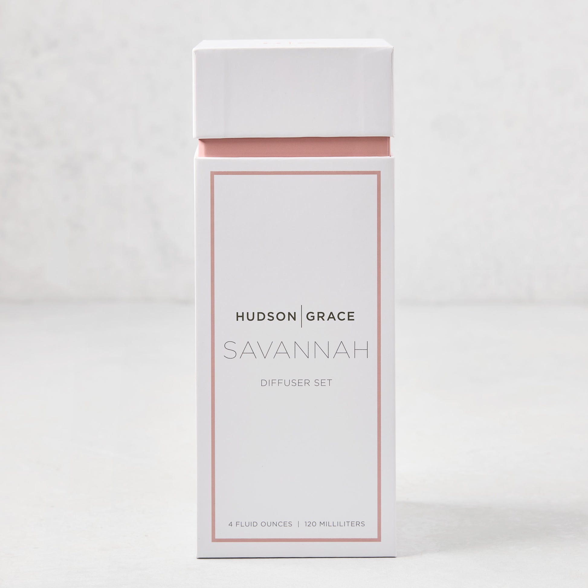 Hudson Grace Savannah scented reed diffuser set in a white and blush pink box.