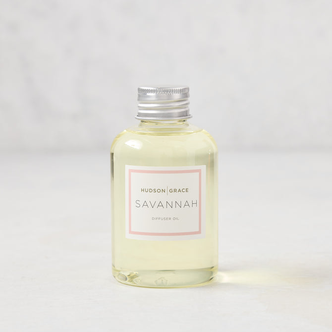 Hudson Grace Savannah scented reed diffuser oil refill, 4oz clear glass bottle with silver cap and pink label.