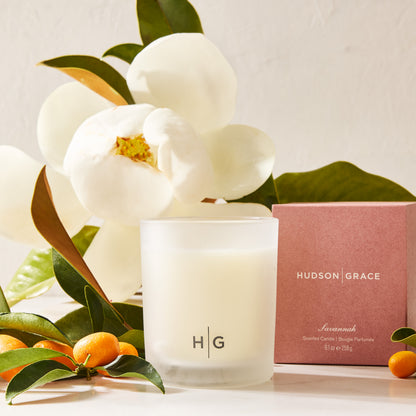 Hudson Grace Savannah scented votive candle in a frosted glass vessel, with magnolia and kumquats.