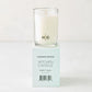 Hudson Grace Sweet Basil Kitchen Candle, white wax in clear glass, on a light teal box with black text.