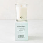 Hudson Grace Sweet Basil Kitchen Candle, white wax in clear glass, on a light teal box with black text.