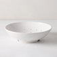 Hudson Grace white ceramic berry bowl, 9"Dia. x 2.5"H, with drainage holes, on a white surface.
