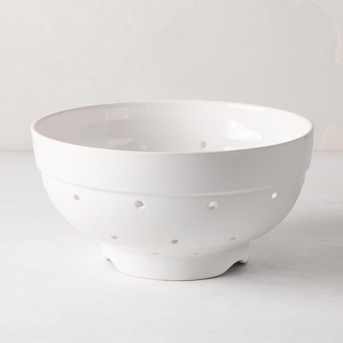 Hudson Grace white ceramic colander, 9.5"Dia x 5"H, with drainage holes and a footed base.