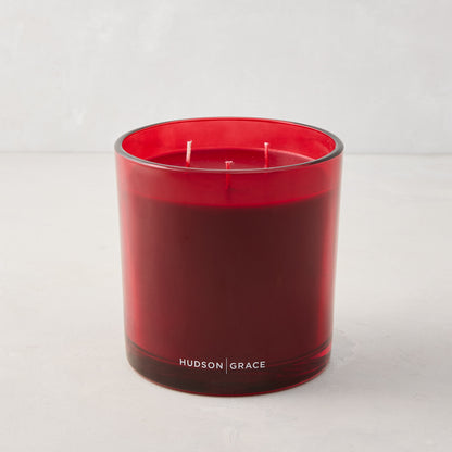 Hudson Grace Winter Scented 3-Wick Candle in a red glass vessel with red wax.