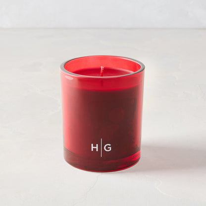 Hudson Grace Winter Scented Candle in a classic red glass vessel with red wax and "HG" logo.