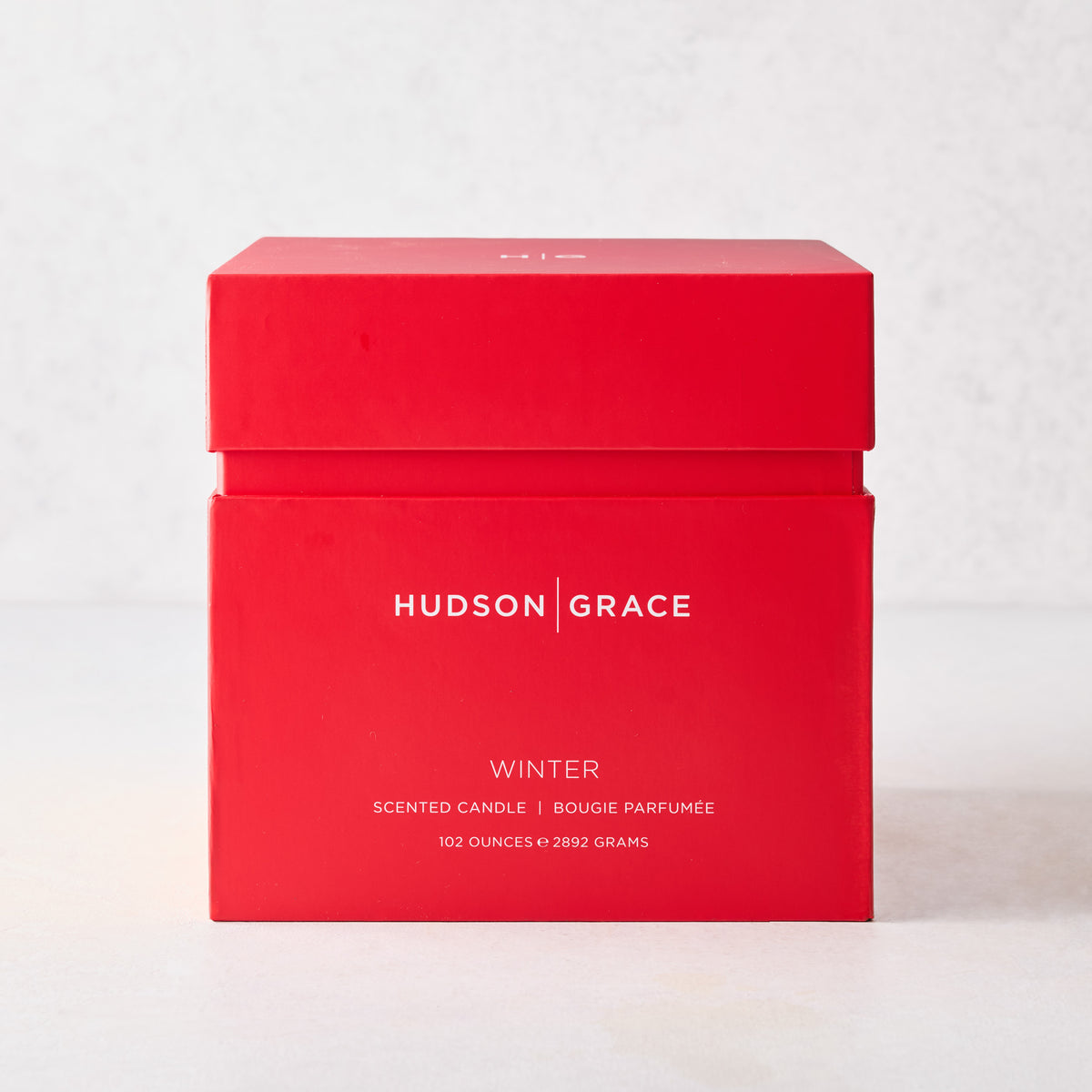Hudson Grace Winter scented grand candle in a large, square red box with white minimalist branding.